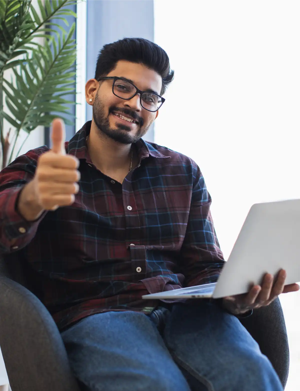 young-man-giving-thumbs-up-while-using-laptop-indo-2025-06-30-18-34-54-utc
